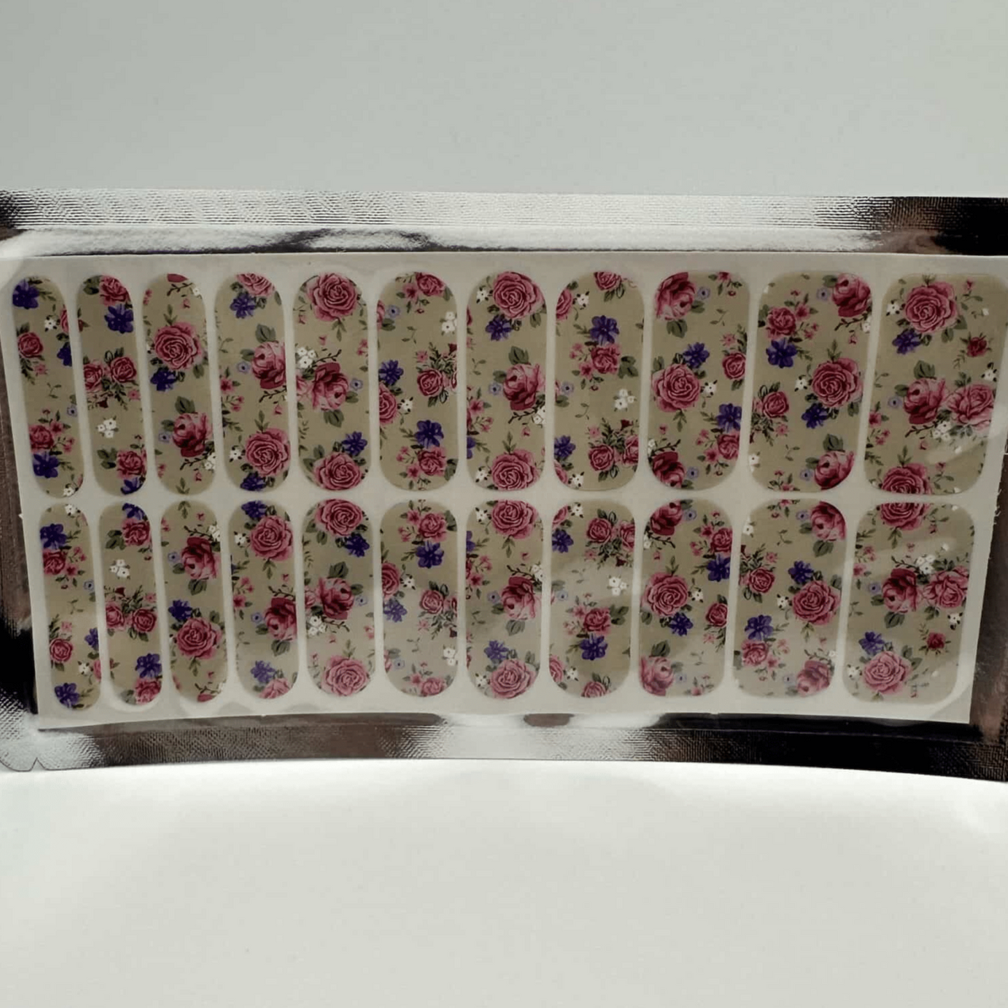 Complete sheet of floral nail wraps featuring pink roses and green leaves