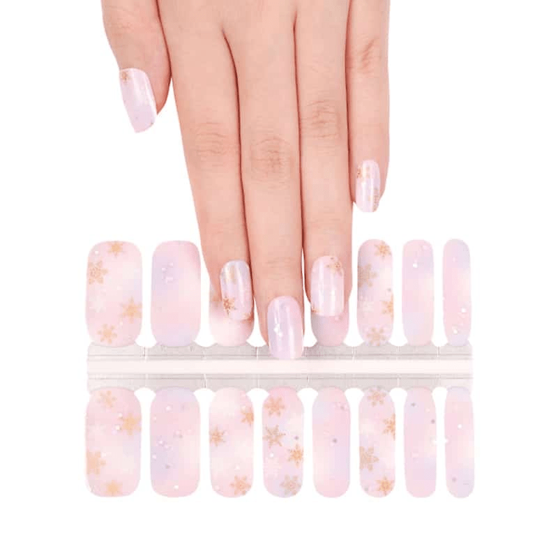 Non-UV nail wraps sheet showing pink gradient snowflake design for at-home manicure application