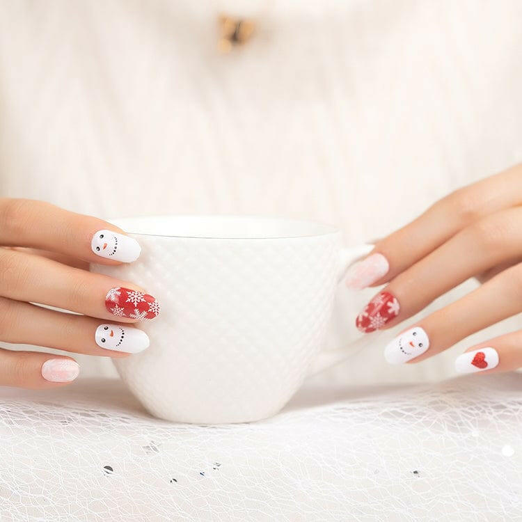 Festive Christmas nail wraps with white snowman designs and red heart accents on hands