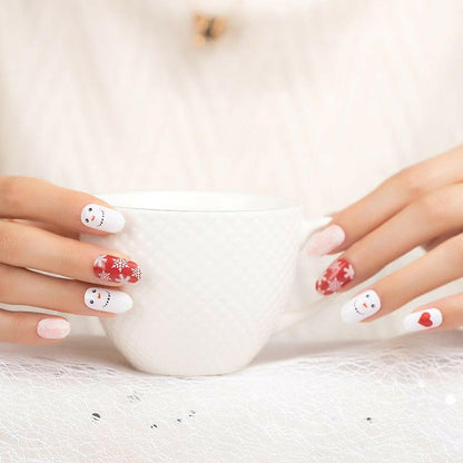 Festive Christmas nail wraps with white snowman designs and red heart accents on hands