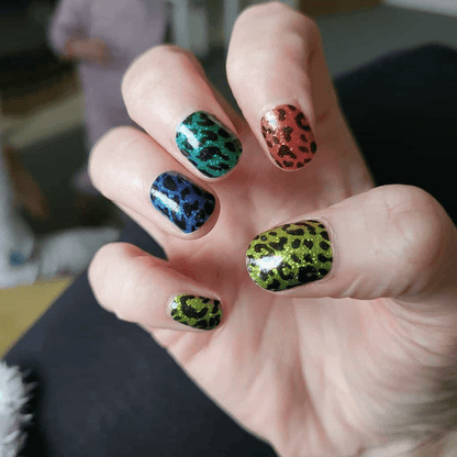 Rainbow leopard print nail wraps on hand showing multicoloured animal print manicure design