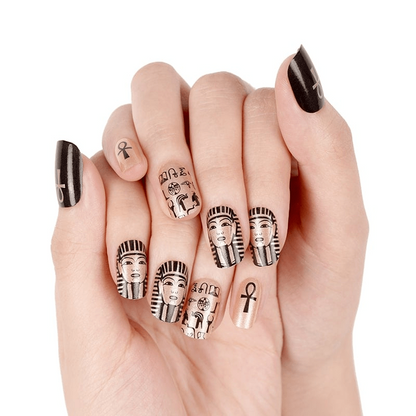Egyptian nail art wraps on hands featuring black and gold pharaoh sphinx designs
