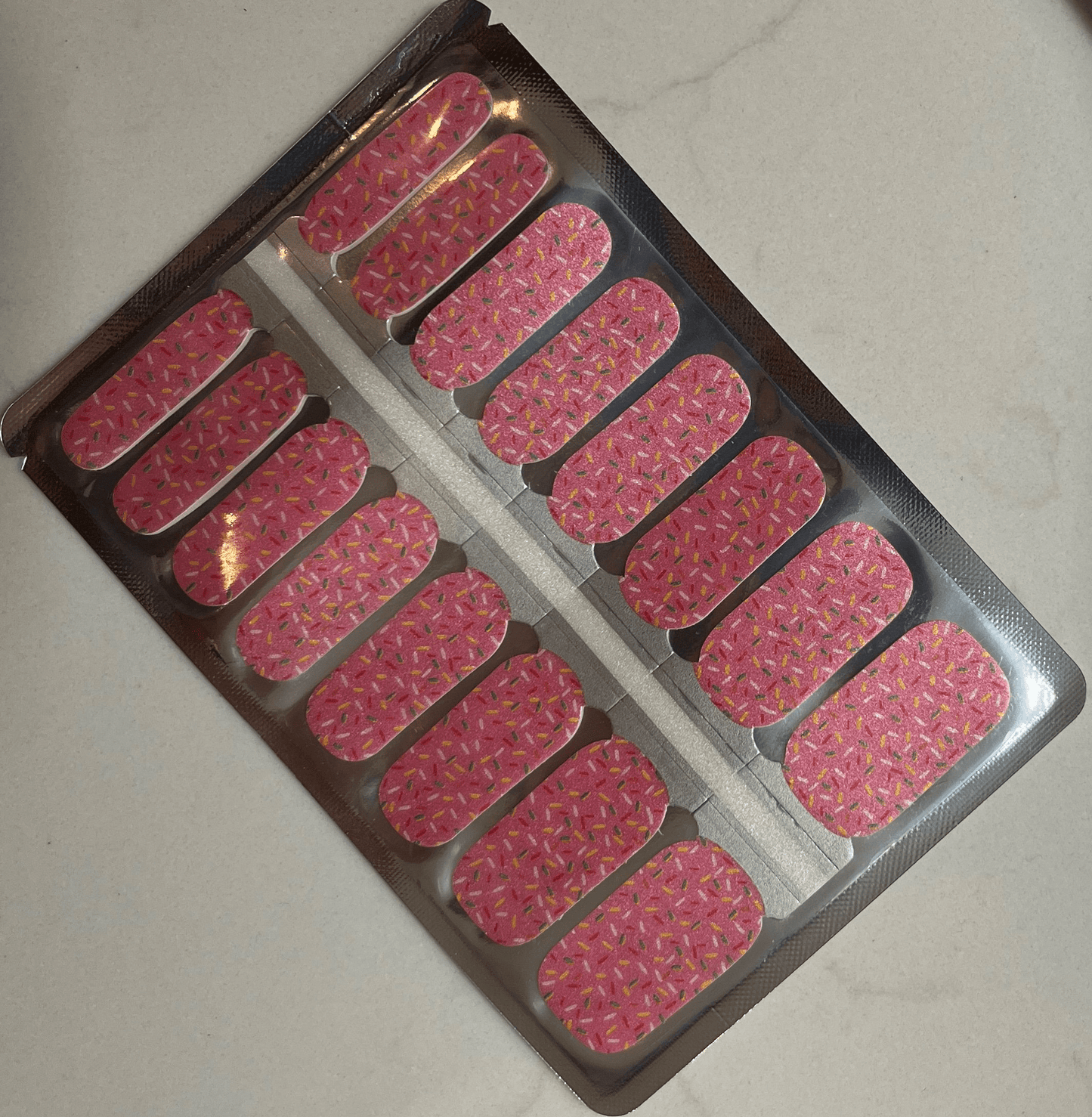 Pink sprinkles nail wraps sheet with colourful confetti pattern for at-home manicure