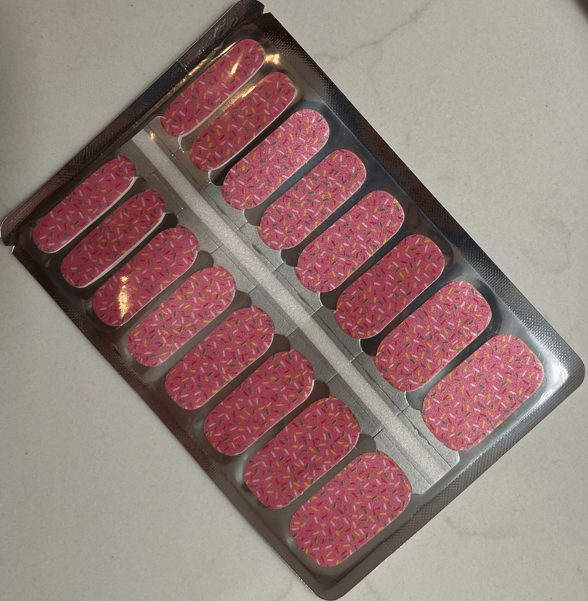 Pink sprinkles nail wraps sheet with colourful confetti pattern for at-home manicure