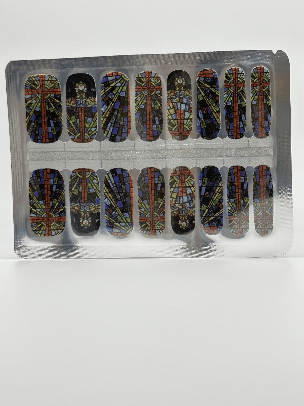 Multicoloured stained glass pattern nail wraps with burgundy navy bronze ornate church window design