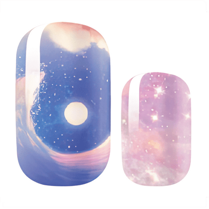 Blue pink galaxy nail wraps with stars and cosmic swirl pattern close-up