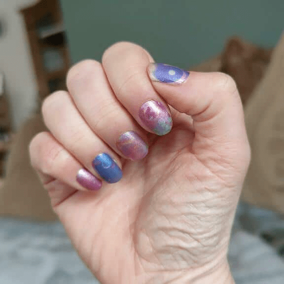 Blue pink purple starry night gradient non-UV nail wraps on hand celestial manicure design