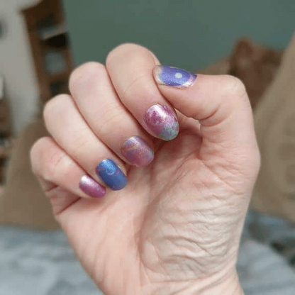 Blue pink purple starry night gradient non-UV nail wraps on hand celestial manicure design
