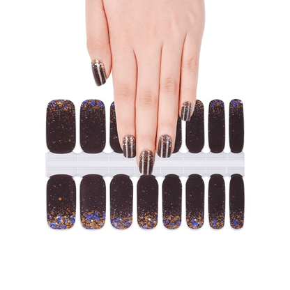 Hand displaying black glitter nail wraps sheet with rainbow confetti pattern design