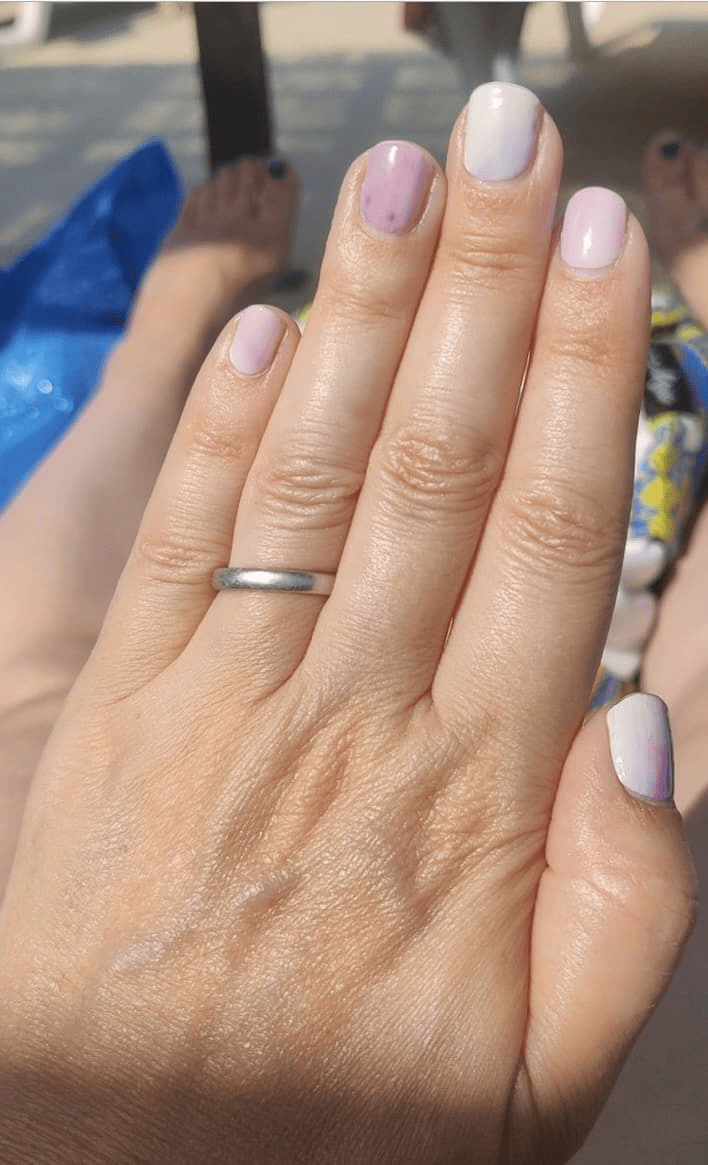 Light purple gradient nail wraps manicure on hands with silver ring