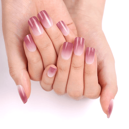 Hands displaying pink ombre gel nail wraps with gradient manicure finish