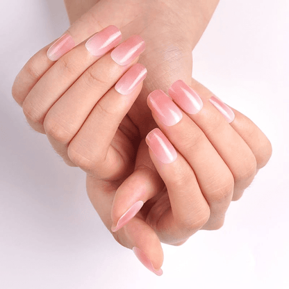 Both hands displaying coral pink glossy nail wraps for at-home manicure