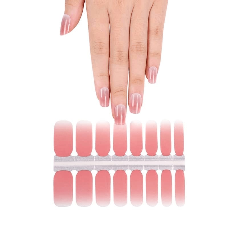 Coral pink ombre nail wraps on hand showing gradient sunset design for at-home manicure