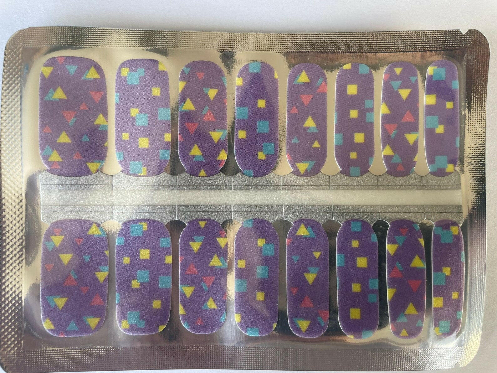Purple geometric nail wraps with colourful triangles and squares retro synthwave pattern