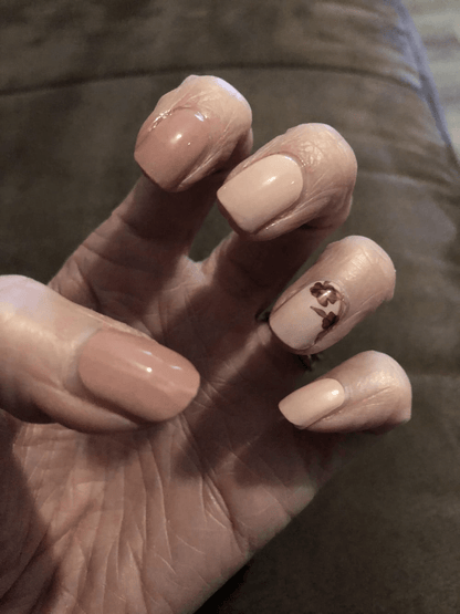 Glossy dusty rose nail wraps with burgundy floral accent design on hand