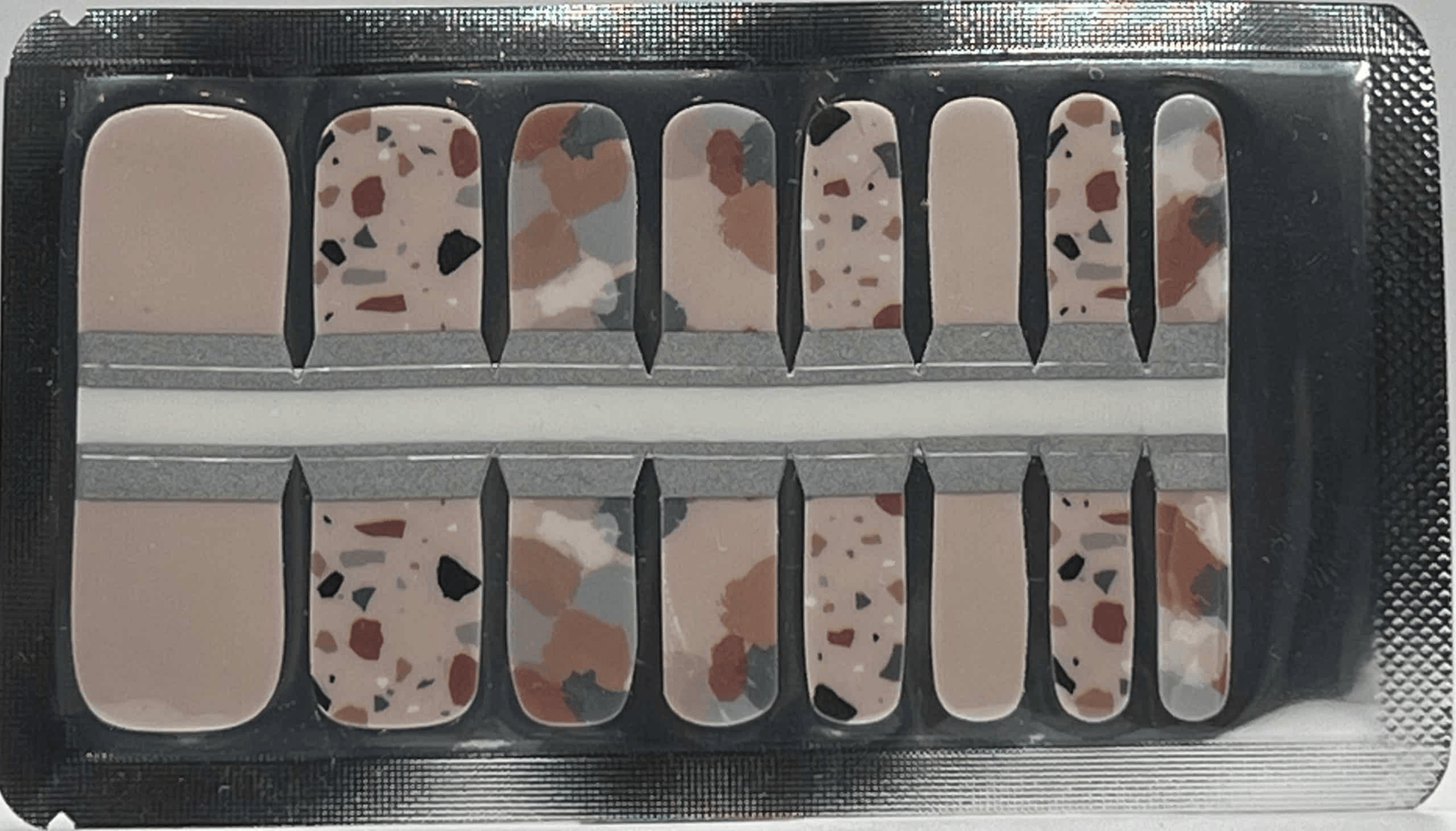 Terrazzo pedicure nail wraps sheet showing speckled stone pattern in neutral earth tones