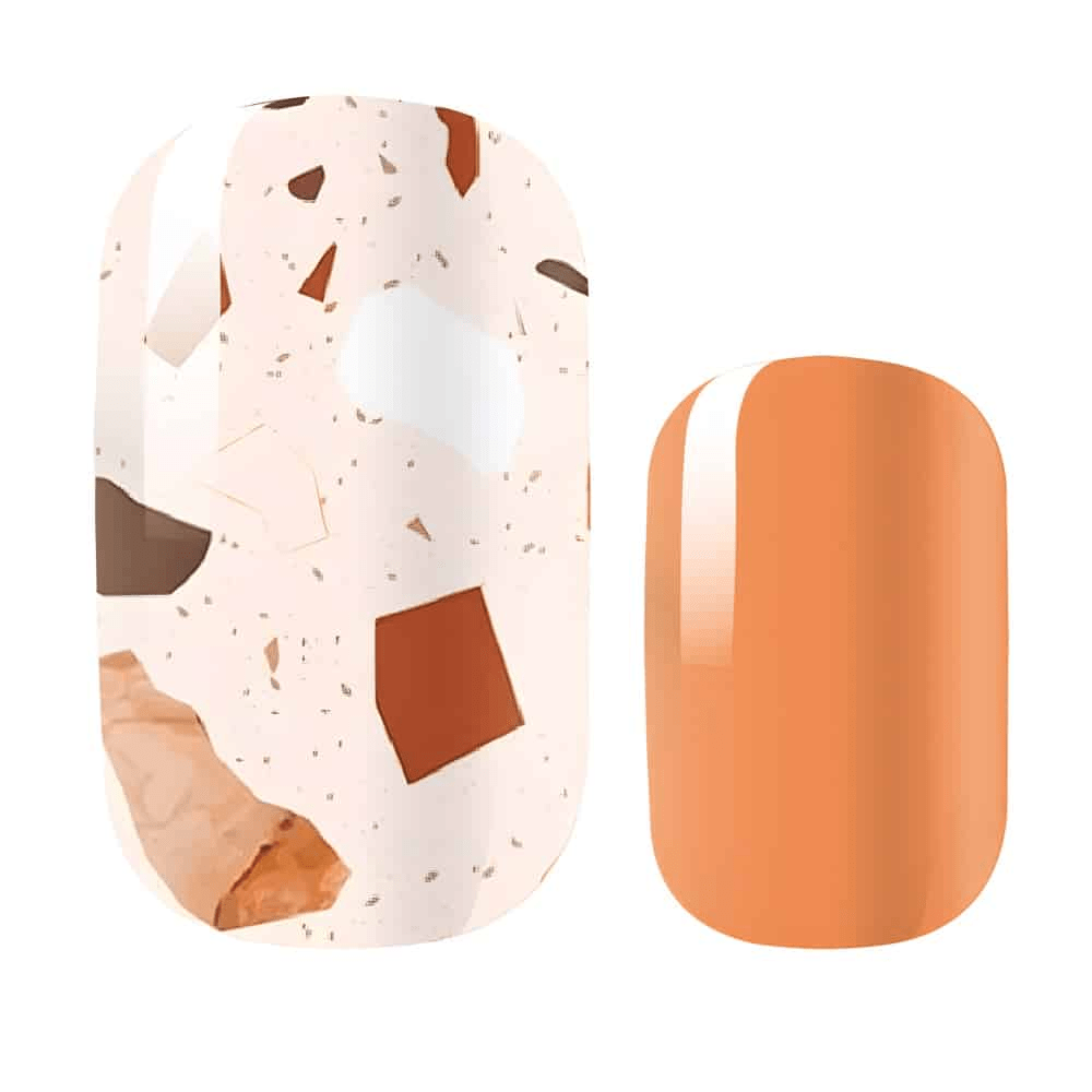 Close-up terrazzo nail art design with warm orange and brown speckled pattern on glossy finish