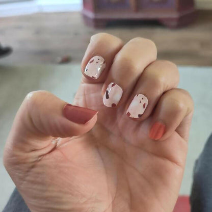 Neutral terrazzo nail wraps manicure with brown and cream speckled stone effect pattern