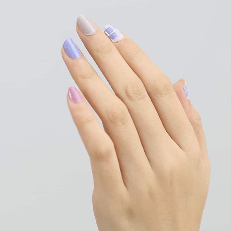 Purple and pink tartan plaid nail wraps on hand showing Scottish pattern design