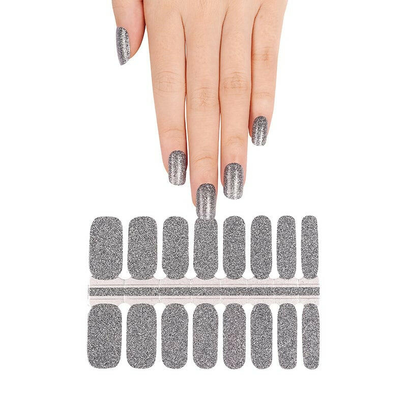Silver glitter nail wraps on hand showing metallic chrome finish for at-home manicure