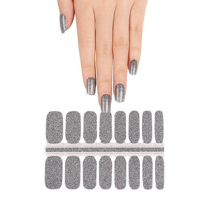 Silver glitter nail wraps on hand showing metallic chrome finish for at-home manicure