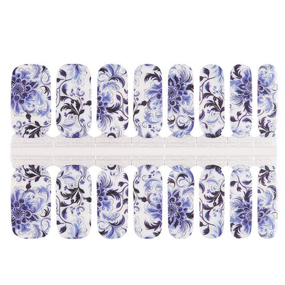 Blue and white porcelain-style nail wrap sheets with delicate floral swirl patterns