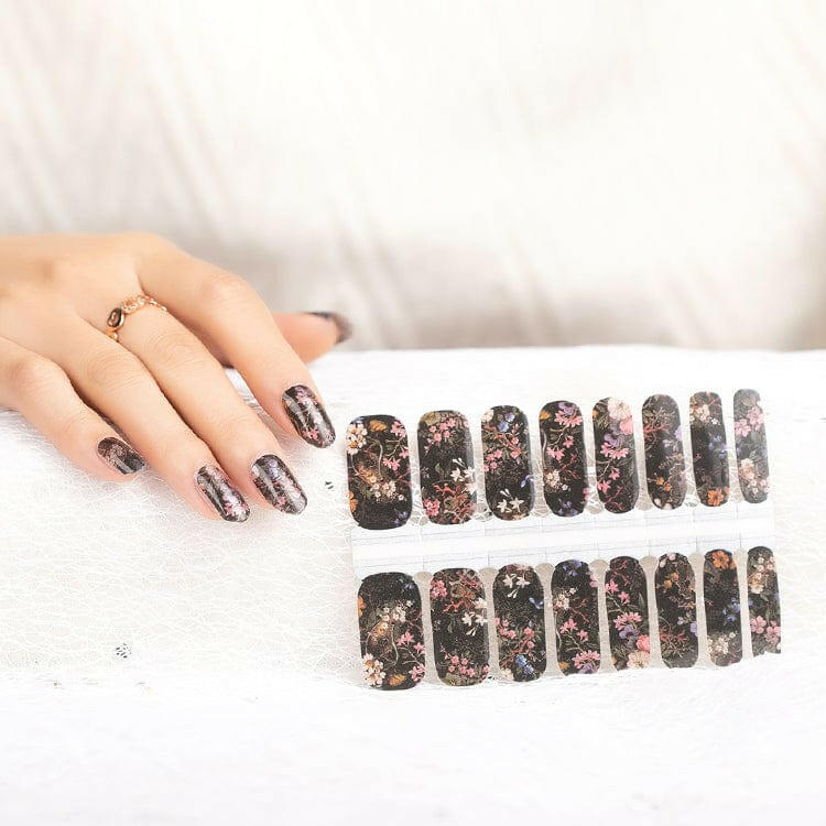 Gothic floral nail wrap sheets with dark botanical patterns and pink accents on black base