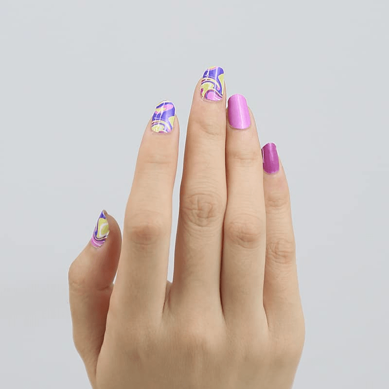 Purple and pink gel nail wraps with psychedelic swirl pattern on hand