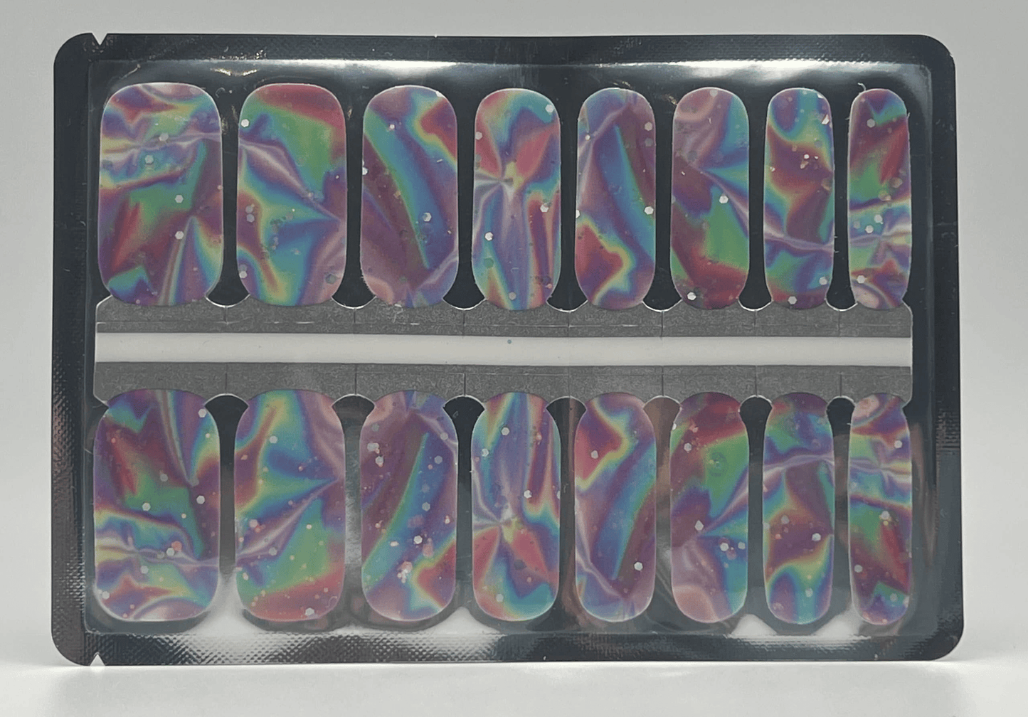 Holographic rainbow nail wraps with psychedelic swirl patterns in packaging for at-home manicure