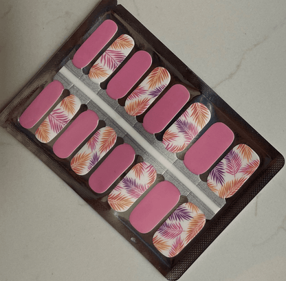 Pink coral nail wraps with tropical fern leaf pattern in packaging