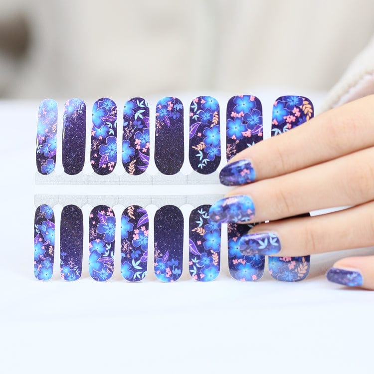 Navy blue floral nail wraps in packaging with watercolour flower patterns