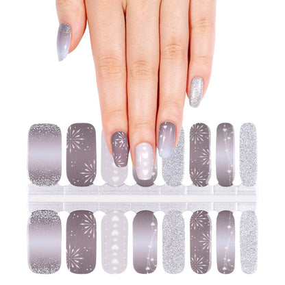 Grey and silver glitter nail wraps with geometric patterns on hand, non-UV nail art designs
