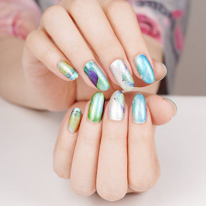 Blue turquoise marble nail art wraps on hands showing water stone design