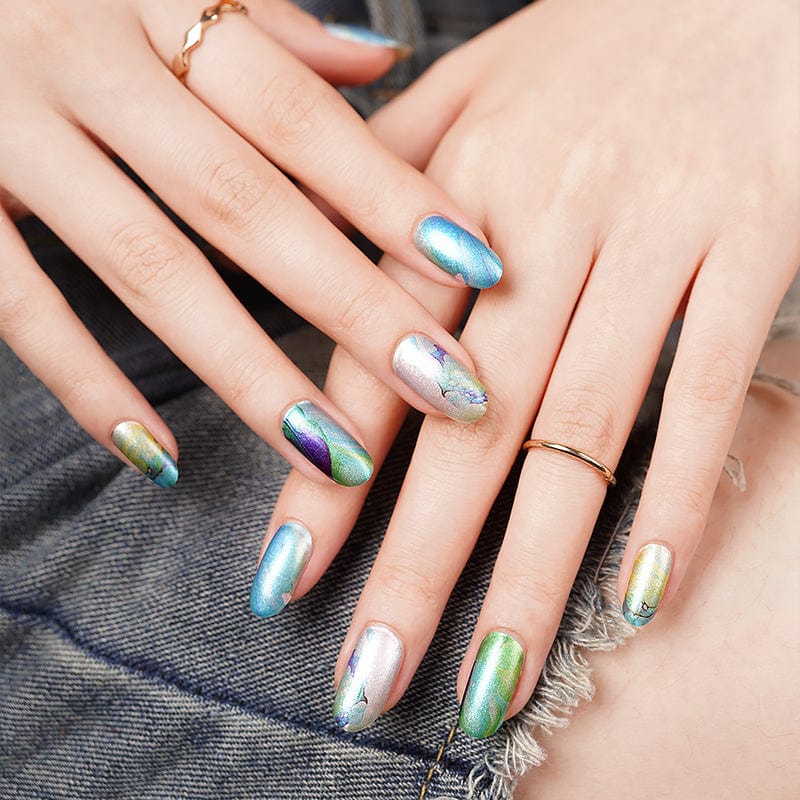 Hands wearing blue green marble nail wraps with turquoise water stone pattern