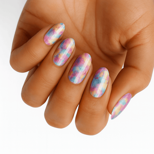Watercolour pastel nail wraps on hand showing dreamy blue pink artistic patterns
