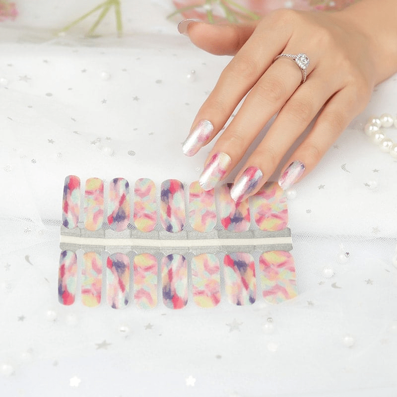 Watercolour nail wrap sheet with hand showing artistic pastel multicoloured patterns