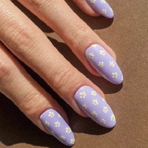 Lilac nail wraps with golden buttercup pattern on almond shaped nails