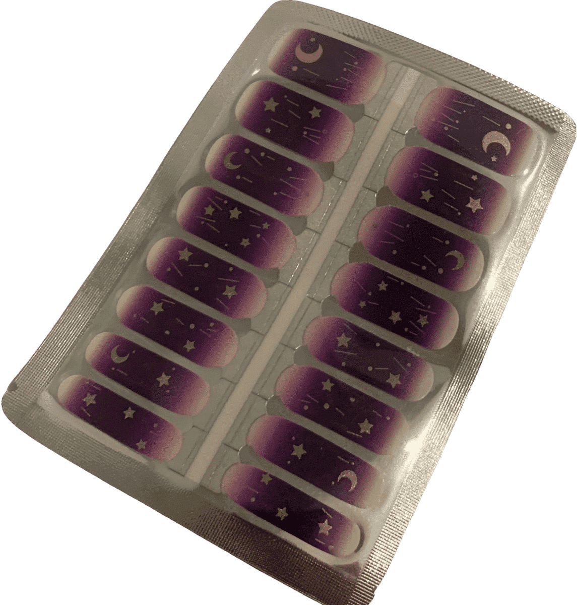 Purple ombre nail wraps with celestial gold designs in packaging sheet