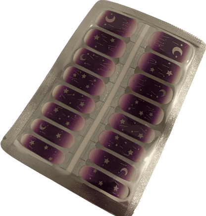 Purple ombre nail wraps with celestial gold designs in packaging sheet