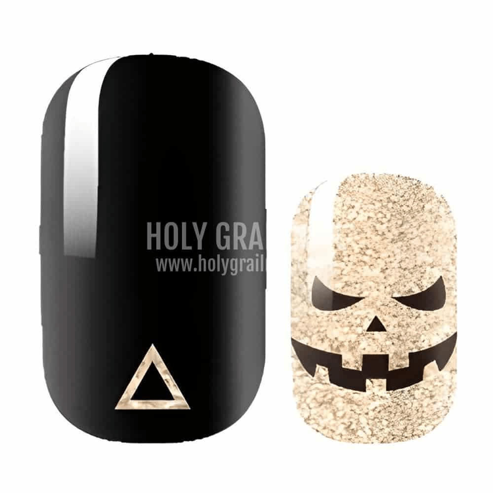 Black and gold glitter pumpkin Halloween nail wrap design with spooky face pattern