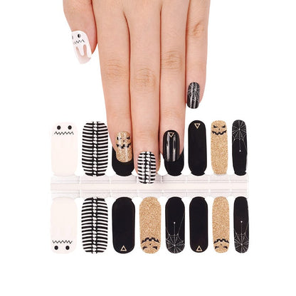 Halloween nail wrap sheet showing ghost, black, gold glitter, and striped nail art designs