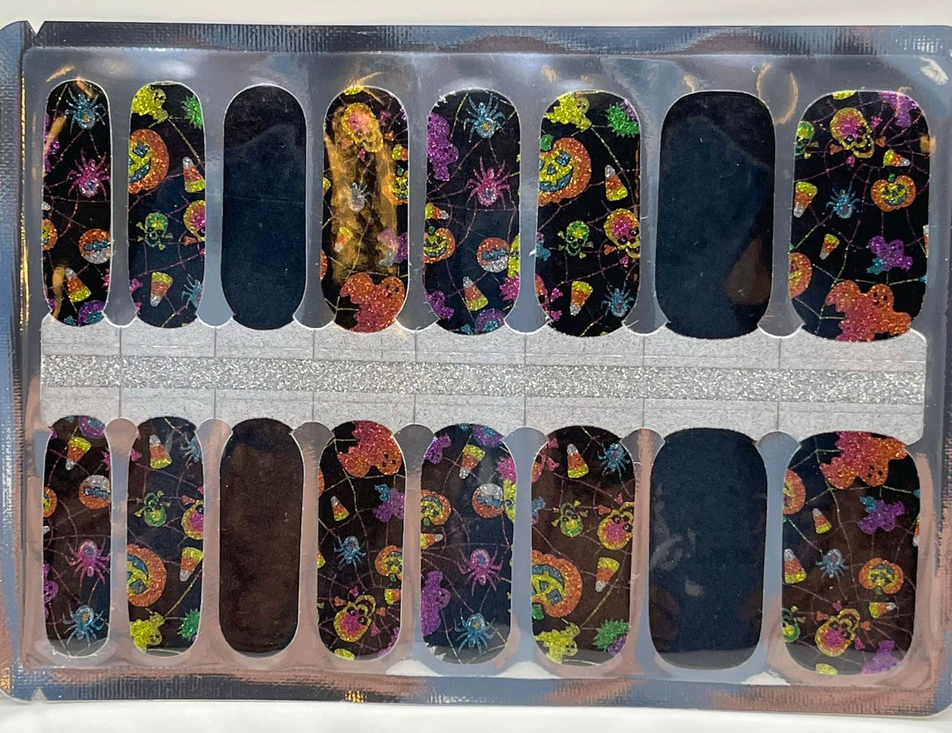 Non-UV nail wraps sheet showing Halloween themed patterns with skulls and colourful designs