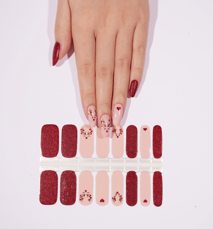 Christmas nail wrap sheet with red glitter and pink floral designs, holiday nail art