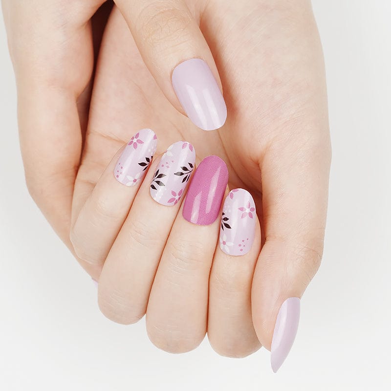 Pink floral nail wraps with delicate botanical patterns on feminine spring manicure