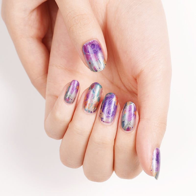 Iridescent chrome nail wraps on hand displaying rainbow holographic mirror effect