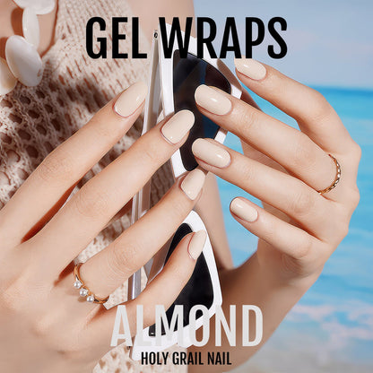 Hands wearing nude gel nail wraps holding glass showing glossy natural finish