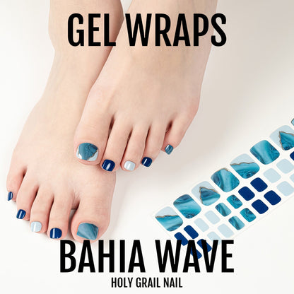 Blue geometric gel pedicure wraps applied on feet showing wave pattern nail art design