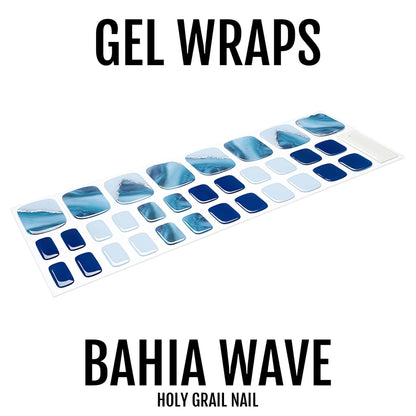 Gel pedicure wraps in blue marble wave pattern laid out for application