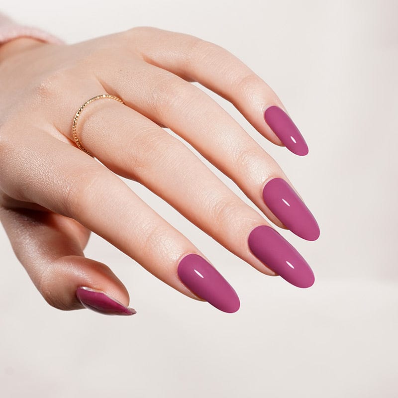 Purple berry gel nails on hand displaying smooth glossy finish manicure