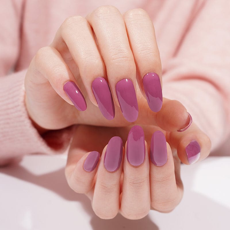 Both hands displaying berry purple gel nail wraps with glossy oval finish